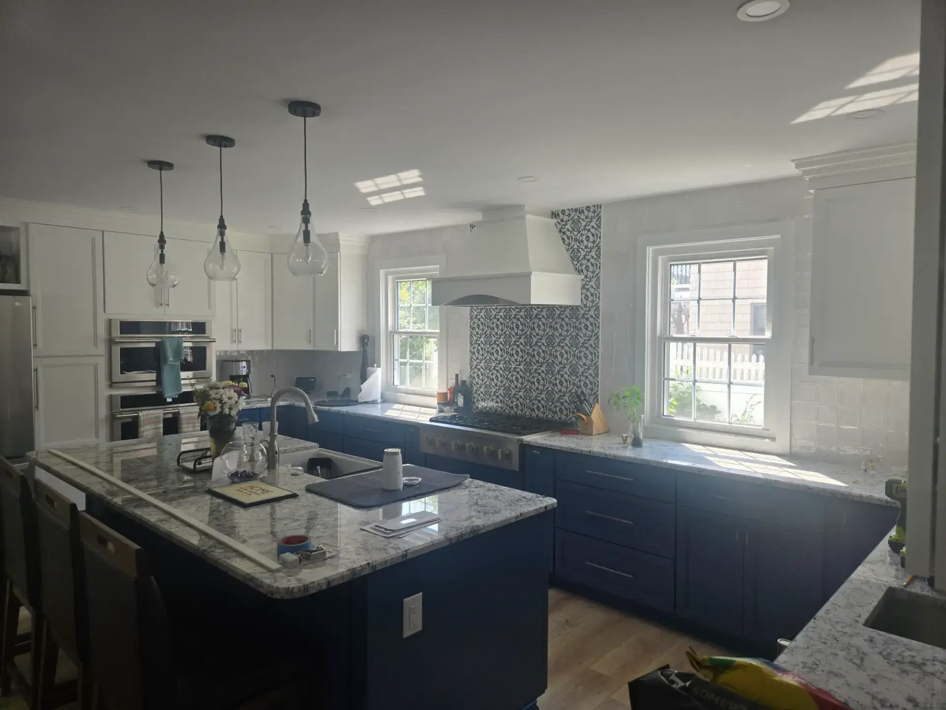 Navy island with a light stone top and matching perimeter counters