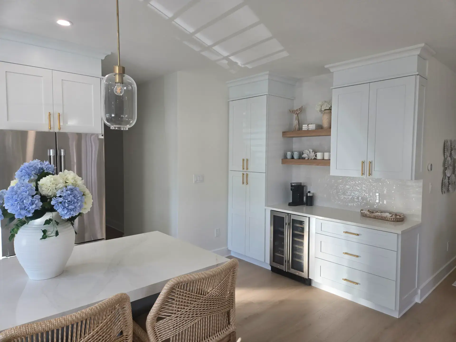 White stone island in a bright kitchen