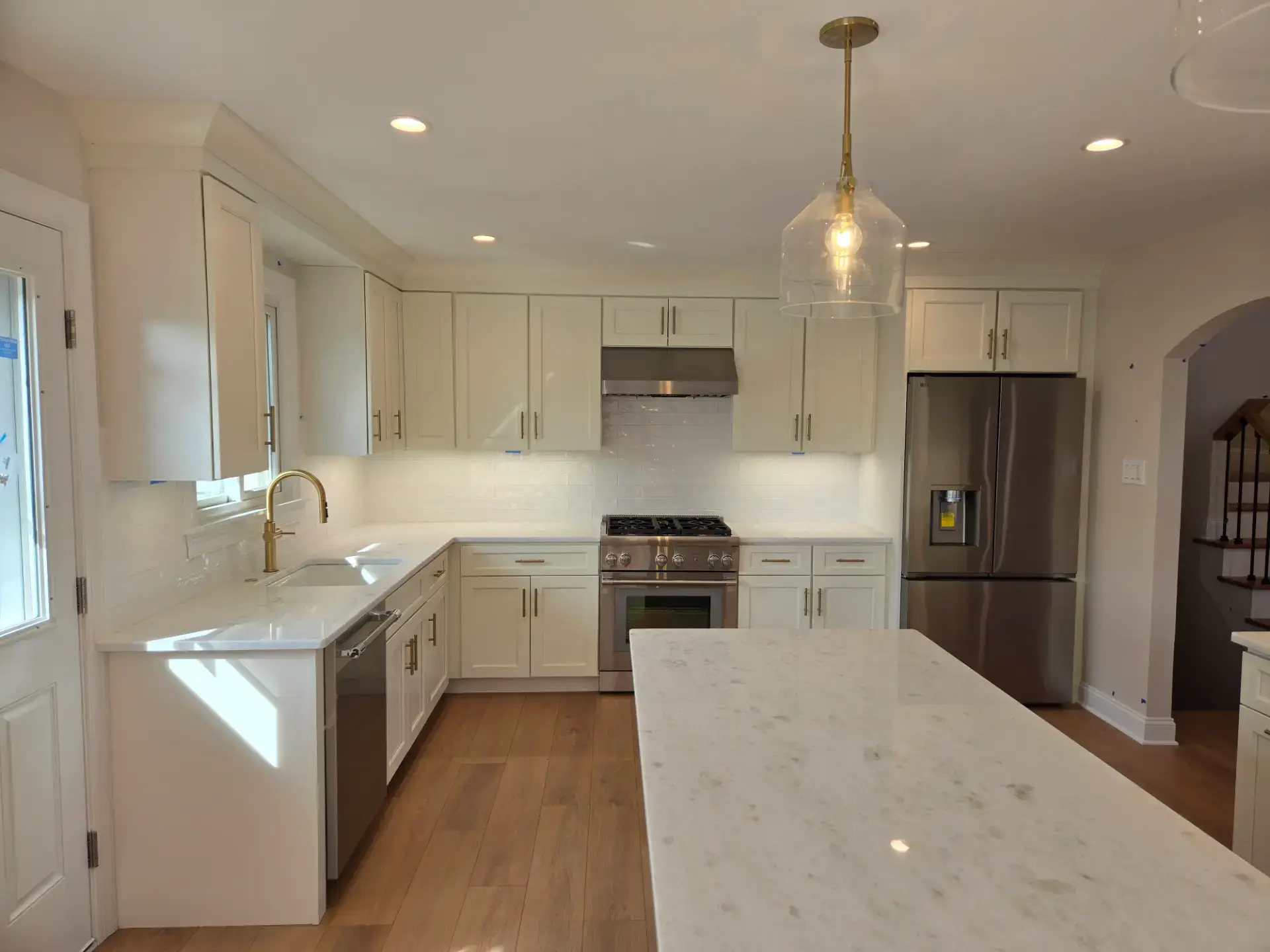 Grey veined stone island in a classic white kitchen